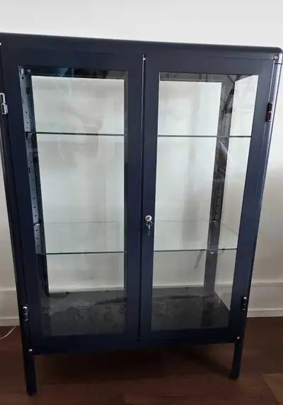 I'm selling an IKEA ABRIKÖR Black-Blue display cabinet. Glass doors and shelving, with a locking mec...