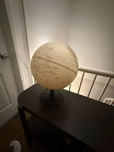 This is a used home decor lot that includes a decorative globe, two elephant figurines, and a set of...