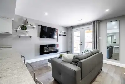Stylish 800 sqft bachelor walk-out basement offers complete privacy with Murphy bed, mini bar island...