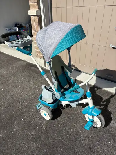 The Little Tikes 4-in-1 Trike in blue and grey is perfect for growing with your child, transforming...