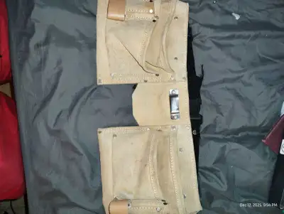 This is a used leather carpenter's belt, perfect for keeping your tools handy on the job. It's showi...