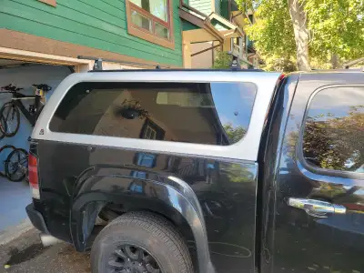 Short bed truck topper with racks. Was on a 2008 GMC Sierra. Fits a bed appropriately 73 inches long...