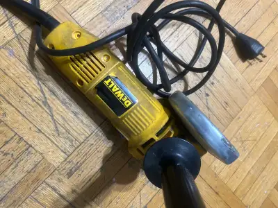 This is a DeWalt angle grinder, perfect for cutting, grinding, and polishing various materials. It's...