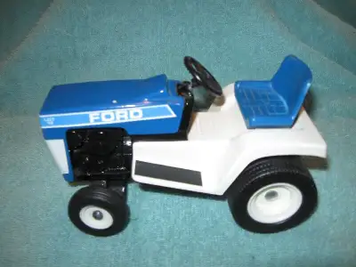 FOR SALE 1984 Special Edition Ford LGT 12 toy garden tractor, is 6 in. long 3 in. wide.