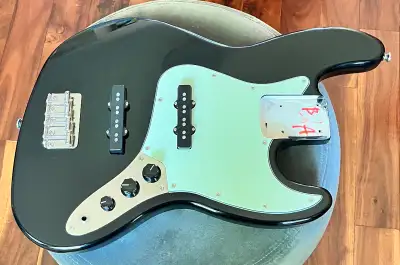 This body comes from a 2022 Squire Classic Vibes 60s Jazz Bass. The body color is black with a gloss...