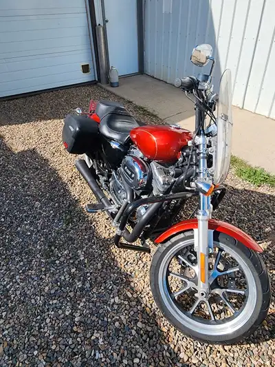 2014 Harley Davidson Sportser 1200XLT touring model. Factory saddle bags, larger gas tank, 2 into 1...