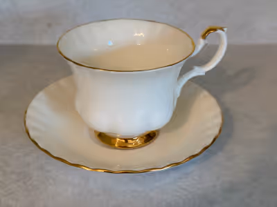 This is a lovely Royal Albert Bone China teacup and saucer in the Val D'Or pattern, featuring elegan...