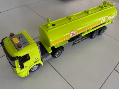 This is a used toy truck that is ready to be played with. It is an oil tanker truck and is green in...