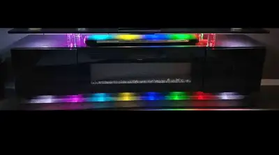 This modern used TV stand features a sleek design and vibrant LED lighting, perfect for elevating yo...