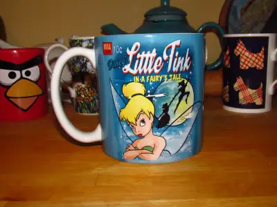 A great looking ceramic DISNEY TINKER BELL coffee cup. The cup measures approximately 4” high with a...