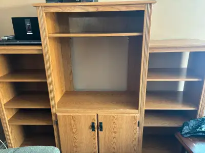 The Tv hole is 28.5 inches wide and 25 inches tall. The whole unit measures It’s 5 feet tall, 74 inc...