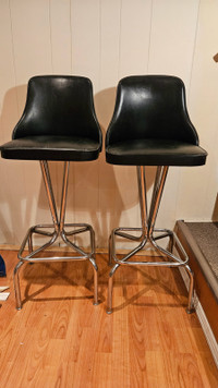 For sale- Two black leather stools for $90.