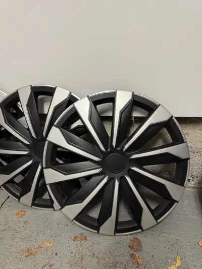 These are wheel covers in silver and black. They are in used condition but still look quite stylish!...