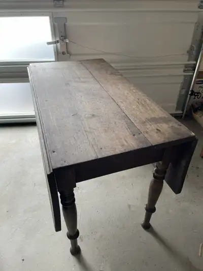 Antique handcrafted kitchen table is full of character and measures 42” x 23” when leaves are droppe...