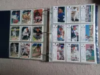 Baseball cards in sleeves in a binder, 2 binders available.