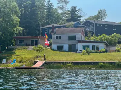Key Features: - Spectacular Lakefront: 112 ft of private frontage on First Lake with direct water ac...