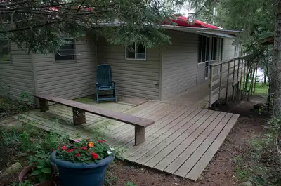 Waterfront, maintenance-free, aluminum-sided cabin with large lakeside deck plus side and back veran...
