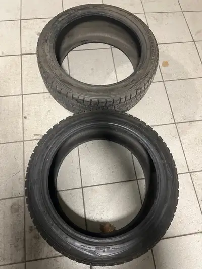 A pair of Dunlop winter tires 245x45x19 in excellent condition One tire has a plug