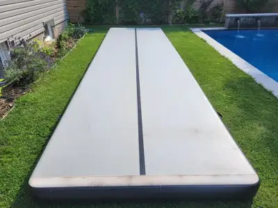 Inflatable tumble track 24' x 6' Includes electric pump and storage cover Excellent condition, used...