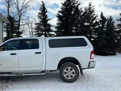 Selling a white Leer truck cap. This used truck cap has tinted windows and provides secure storage a...