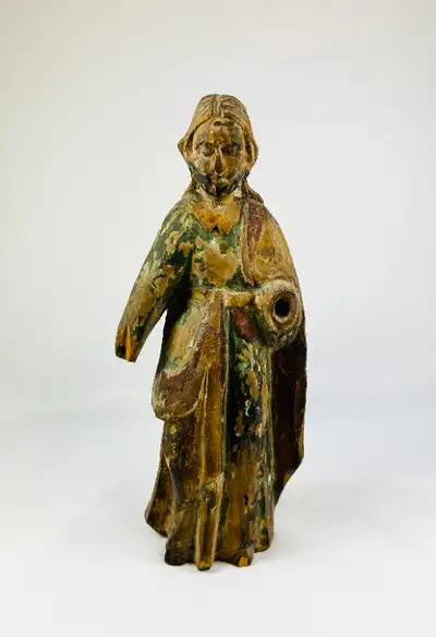 This charming antique wooden statue, dating back to the 17th-18th century, represents a saint or rel...