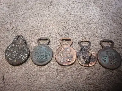 I am offering a set of five decorative bottle openers, each with unique bronze designs and a vintage...