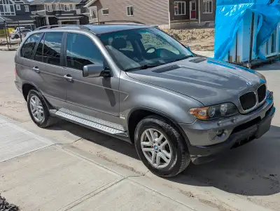Gray BMW X5 3.0i SUV. Comes with heated black leather seats in front and back. Power windows, power...