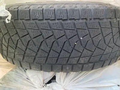 For sale are four Bridgestone winter tires mounted on steel wheels, sized at 225/65R17. These tires...