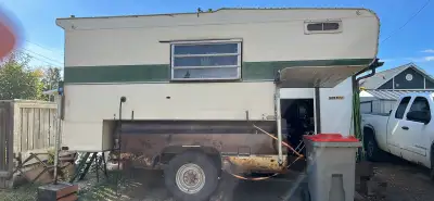 10 1/2 ft skylark truck camper. No leaks, everything works. Comes with homemade truck box trailer.