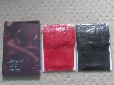A new pack of Lidogirl Lace Top Thigh High Stockings - One red, one black. Material is 95% nylon, 5%...