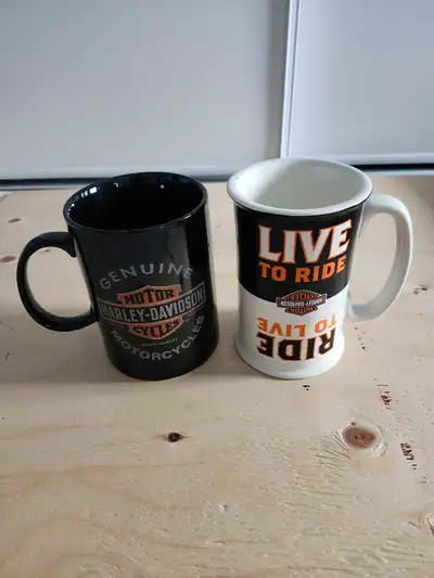 Two Harley-Davidson Mugs. Never used. The white one is a double-sided mug. $15 each or $25 for both....
