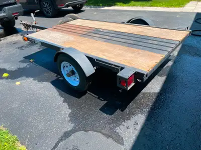 Flat bed utility trailer. Floor type is a combination or steel and lumber. Comes with 3 spare tires....