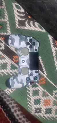 PS4 wireless  controller equipped with scuffed thumb grips 