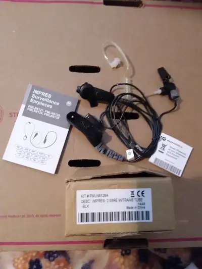 Brand new. Radio ear headset. It has two cords, one for the earpiece and one for the microphone /PTT...