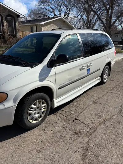 2003 Dodge Caravan handicap van. Side loading ramp. Wheelchair tie downs in place of front passenger...