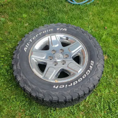 BFGoodrich All-Terrain tires mounted on chrome GMC wheels The tires show moderate tread wear consist...