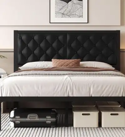Upgrade your bedroom with this stylish queen bed frame, featuring a sleek black metal frame and a bu...