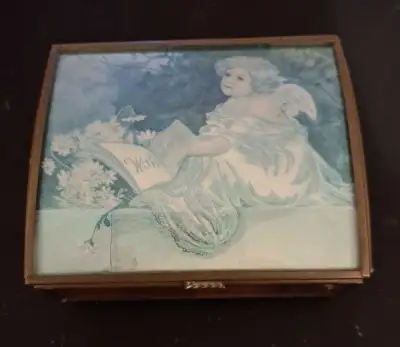 This vintage Enesco music box, crafted by Via Vermont and featuring artwork handcrafted Thomas Cathe...