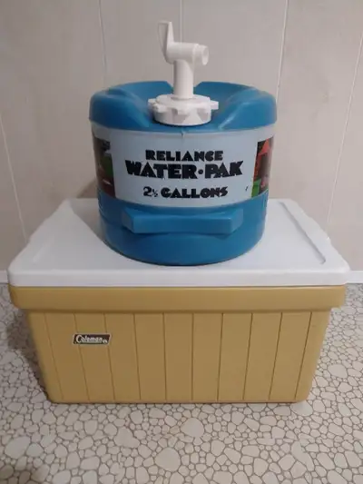 Plastic Coleman cooler that measures 34 x 53 cm and 31 cm tall with the lid. Also a plastic 2.5 gall...