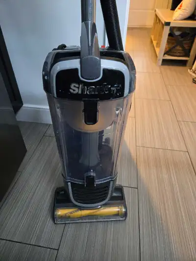 This is a used Shark corded vacuum, perfect for keeping your home clean with its powerful suction an...