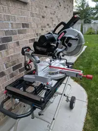 10 in . MITRE  SAW with  NEW  ROLLING HYDRAULIC  DELTA STAND.