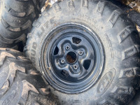 Set of 4 ITP tires and rims with center caps. 4 hole