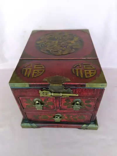 A nice, vintage Asian jewelry box with lots of drawers. It has a folding mirror on the top, and spac...