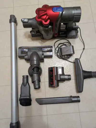 Dyson DC35 Multi Floor cordless vacuum in gray and red. This unit has a motorized floor tool, a mini...