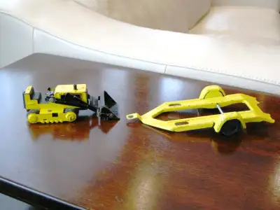 I have Two (2) Vintage Tonka Pressed Metal Steel Toys - One Snowmobile Trailer and small Bulldozer....