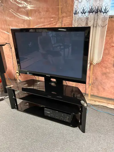 Two Items Available for Sale: - Item 1: -inch Samsung Plasma TV - Item2: High-Quality Glass Top TV S...
