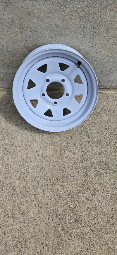 I'm selling a used white trailer rim, size 13.5x 4.5 in. with a 5-bolt pattern, perfect for your tra...
