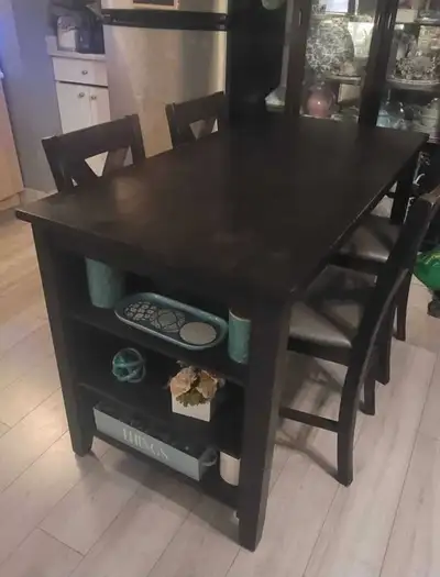 This elegant dark wood dining table is the perfect addition to any dining room, providing a sophisti...