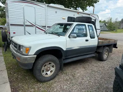 1993 toyota 4x4, 4 cylinder, 5 speed. New flat deck, very minor surface rust, clean cab, new windshi...
