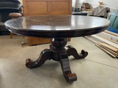 Gorgeous pedestal style table, 54” round, heavy pedestal base, solid wood, a few scratches on top se...
